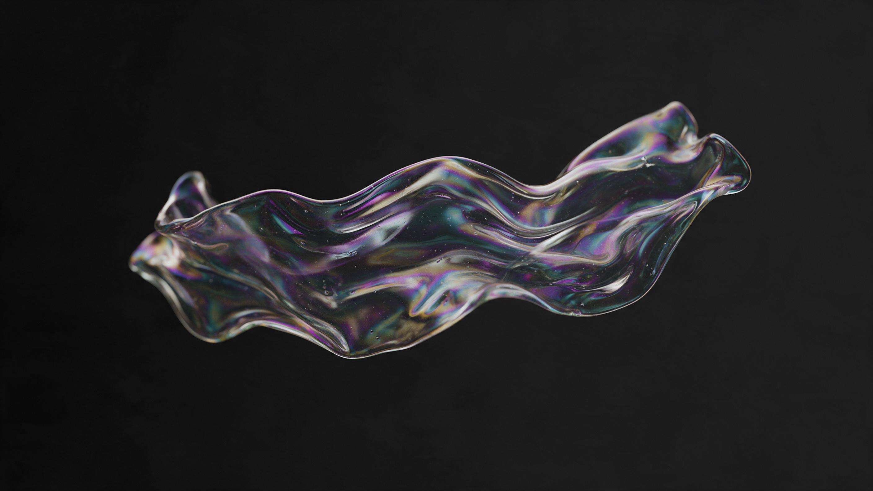 A flowing ribbon of iridescent molten glass suspended in mid-air, its surface rippling with captured light and shifting hues of violet, teal and gold, set against a matte black void, macro detail of internal swirls and tiny bubbles, soft studio lighting from a single source, creating gentle reflecti