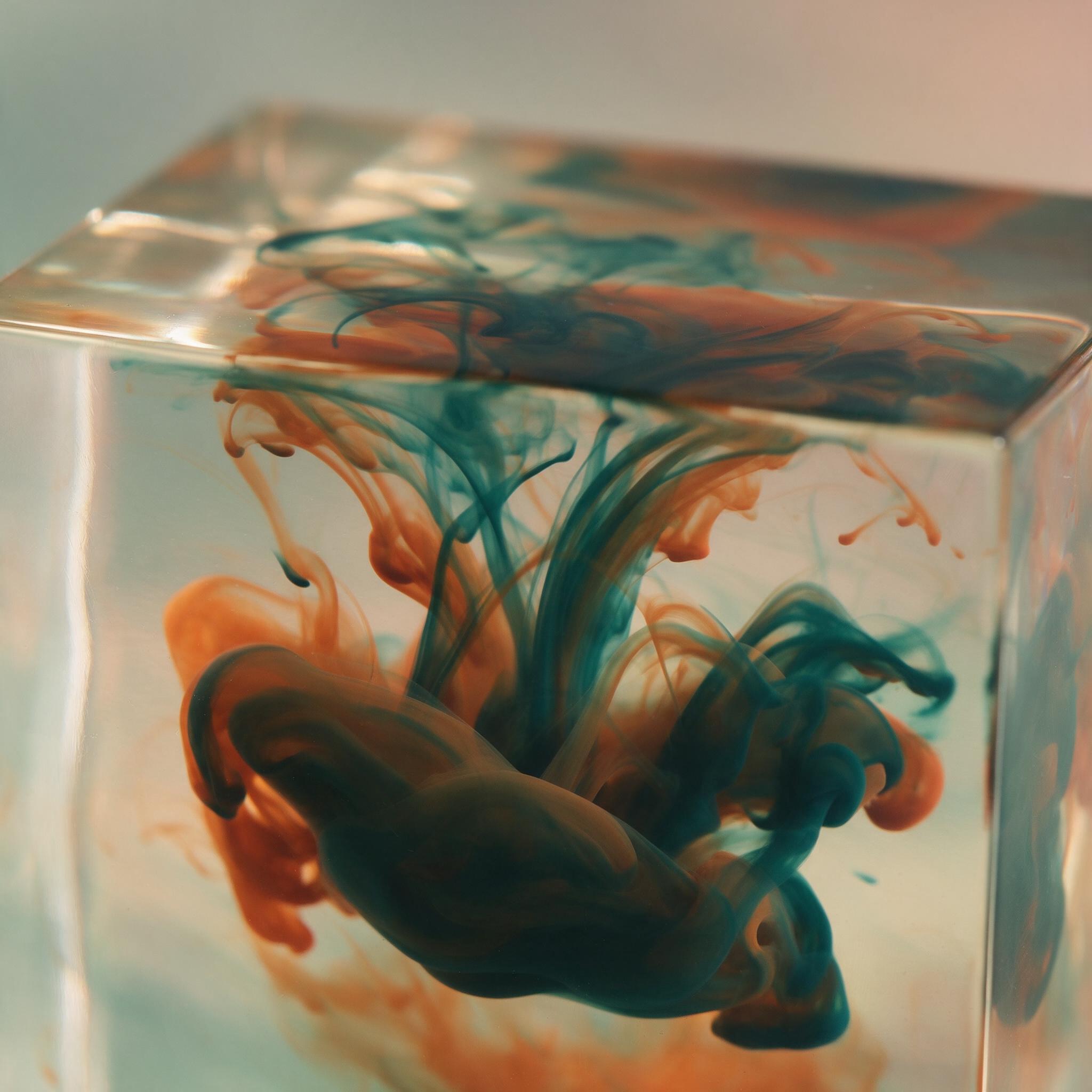 Fluid ink swirls in deep teal and burnt orange, suspended in clear resin, macro view with soft caustic light from above, gentle gradient background, smooth glossy texture, minimalist composition