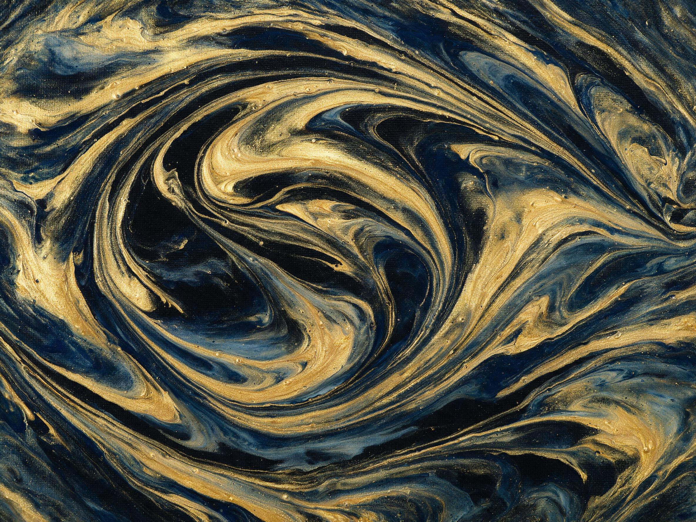 A fluid art composition of swirling gold and deep indigo, metallic pigments merging on a black canvas, macro view with soft studio lighting, slight reflections, minimal sharpness, no text or recognizable shapes.