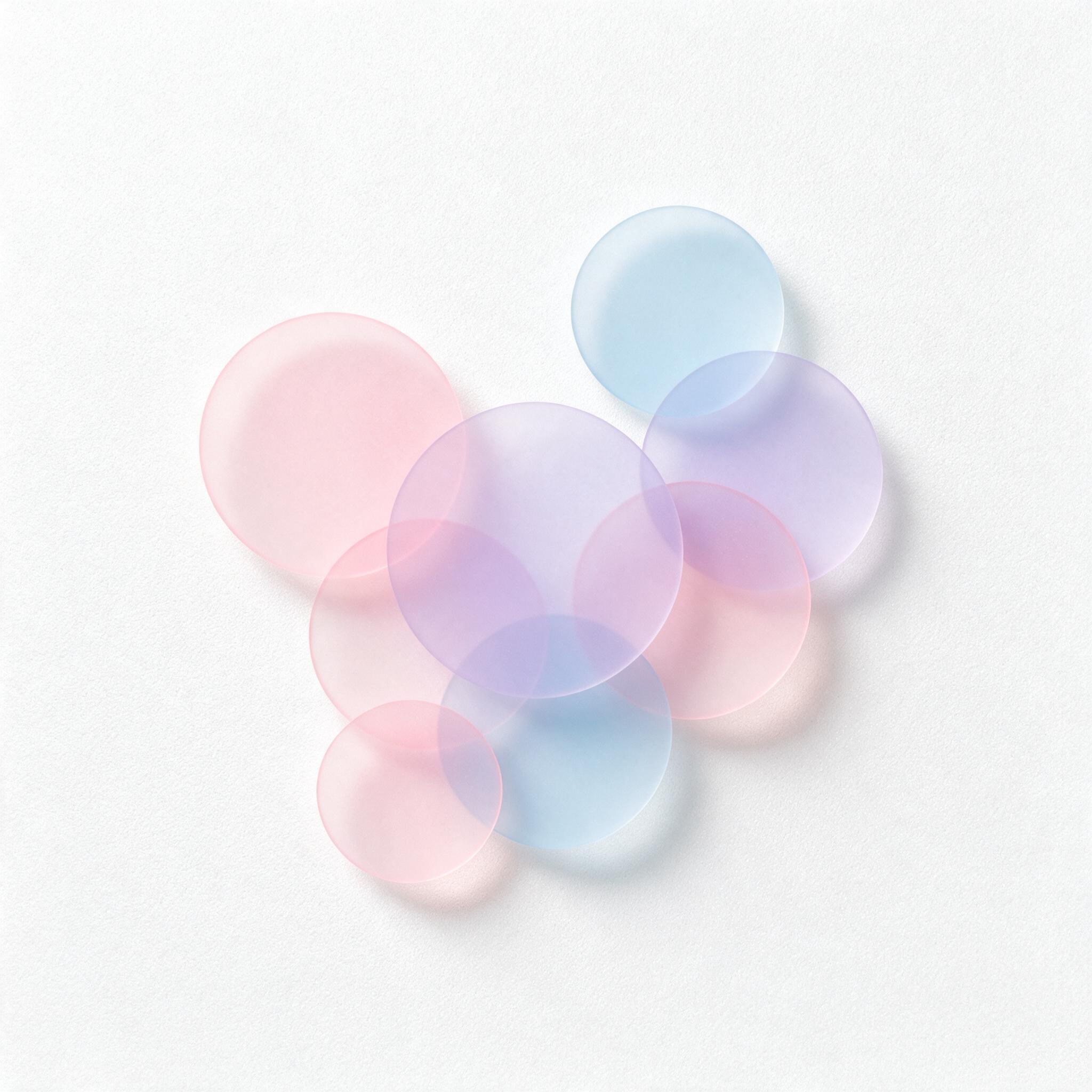 A minimalist composition of overlapping translucent pastel circles in soft pink, lavender, and pale blue, gently floating on a clean white background, with soft diffused light creating subtle shadows, calm and serene atmosphere, slight grain texture for depth