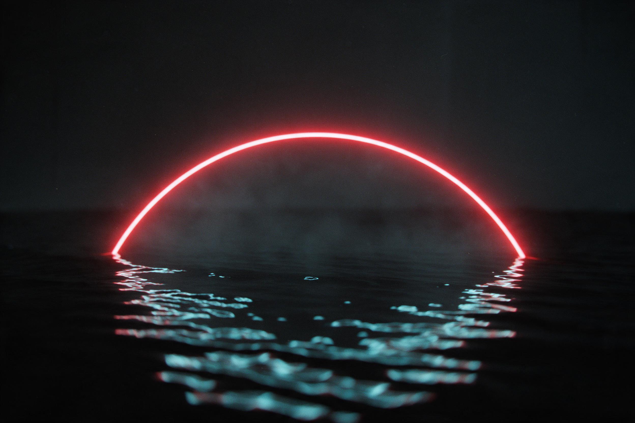 Minimalist composition of a single glowing red neon line arcing over a rippled black water surface in a dark space, with soft cyan reflections from the line below, subtle mist and fine grain, slight camera shake, moody and calm atmosphere