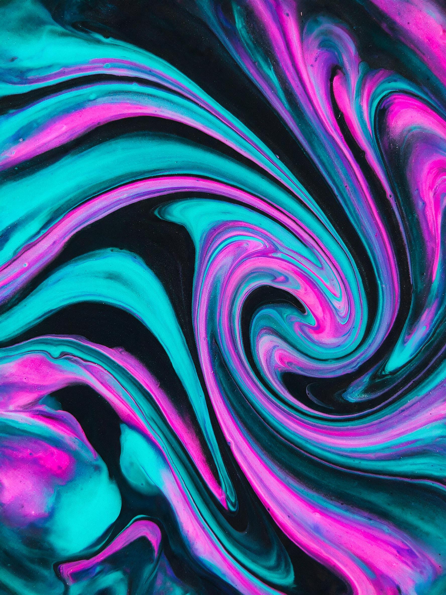 Vibrant neon fluid art, swirling cyan and magenta acrylics on a dark canvas, dynamic organic curves, soft ambient glow, macro close-up view emphasizing glossy texture, slight grain, minimal sharp shadows.