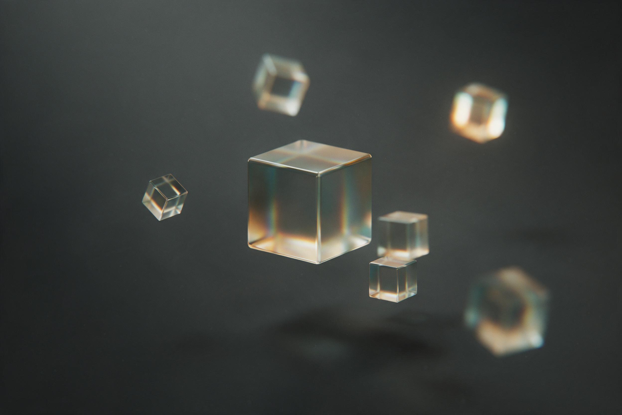 A minimalist abstract composition of floating translucent glass cubes, each refracting soft warm amber and cool teal light, against a matte charcoal background with gentle haze, subtle grain, shallow depth of field, sharp focus on central cube, ambient studio illumination with soft shadows.